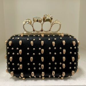 NWT knuckle clutch with skulls and studs